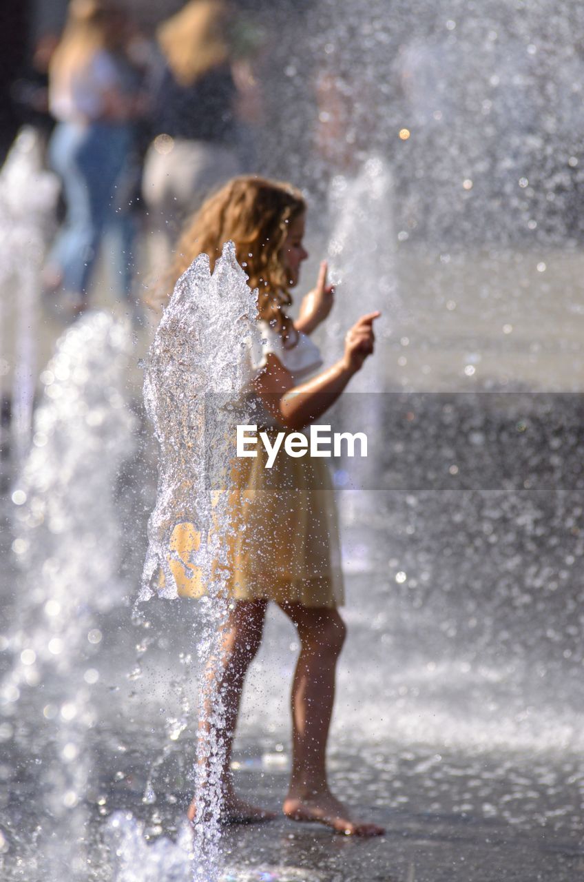 FULL LENGTH OF WOMAN IN WATER