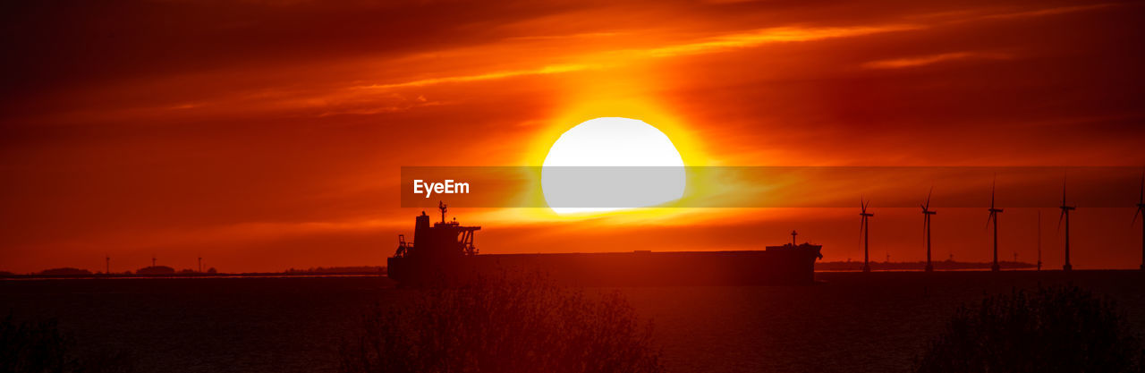 SCENIC VIEW OF SEA AGAINST ORANGE SKY DURING SUNSET
