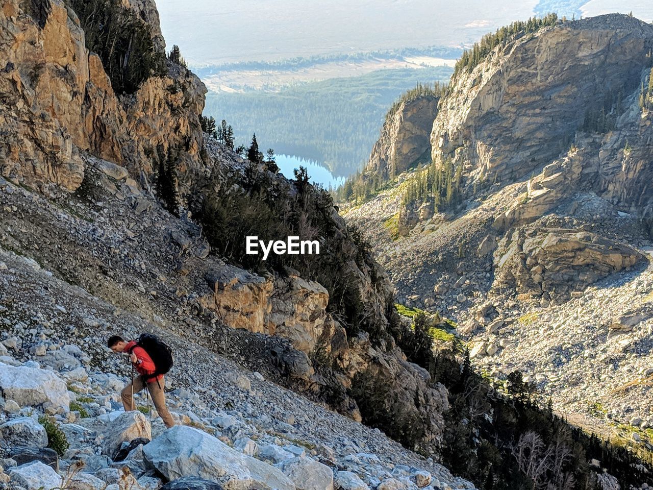 Side view of man climbing on rock formation