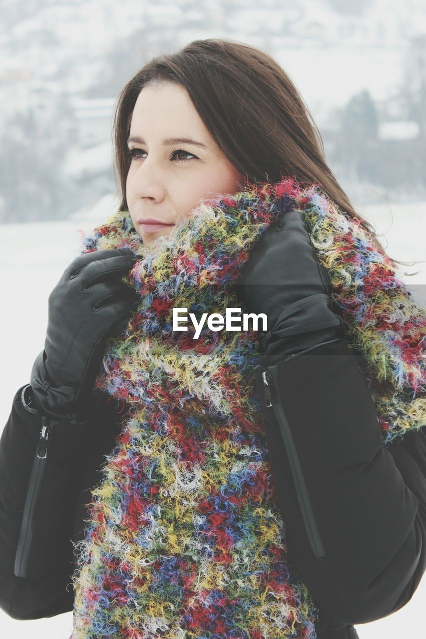 Mid adult woman wearing warm clothing while looking away outdoors