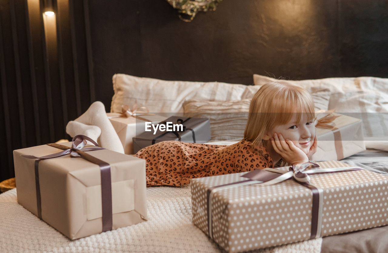 Portrait of smiling child sitting on sofa at home