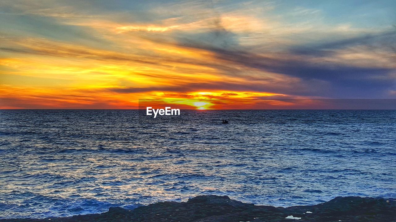 SCENIC VIEW OF SEA DURING SUNSET