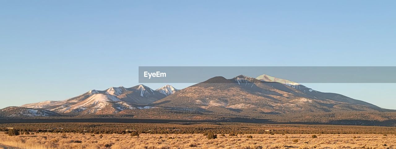 SCENIC VIEW OF MOUNTAIN RANGE AGAINST CLEAR SKY