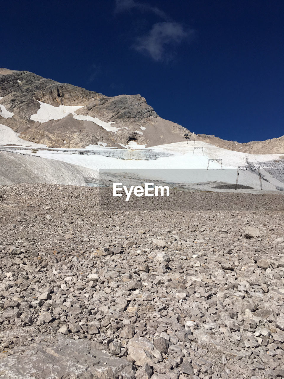 Scenic view of snowcapped mountains against blue sky