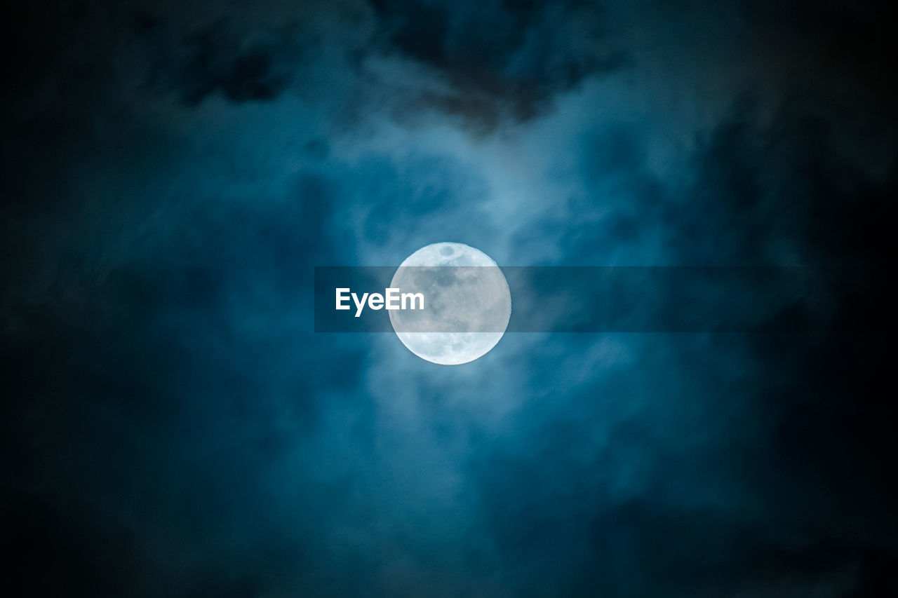 LOW ANGLE VIEW OF MOON IN SKY