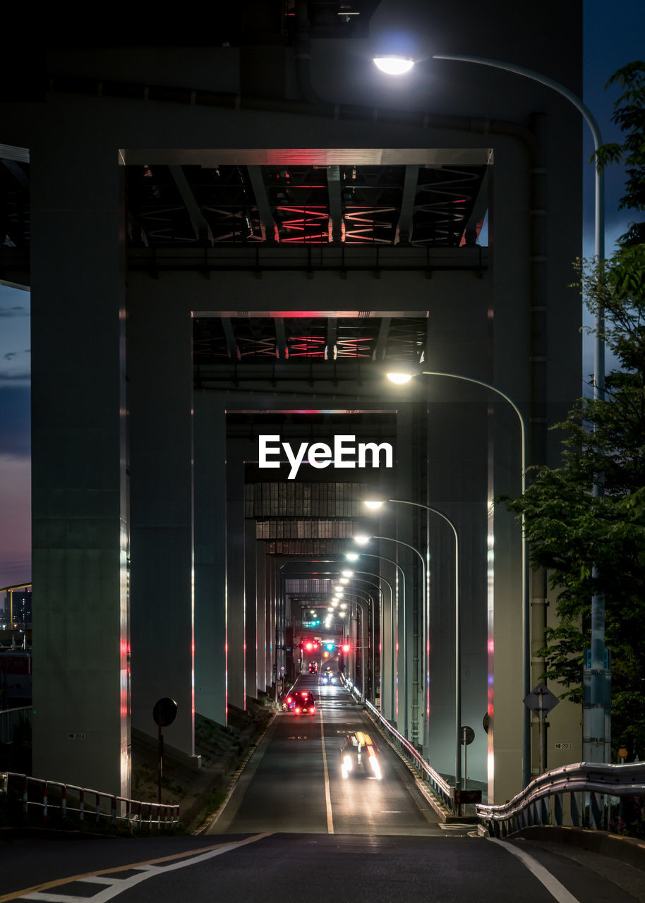 Illuminated underpass in city at dusk