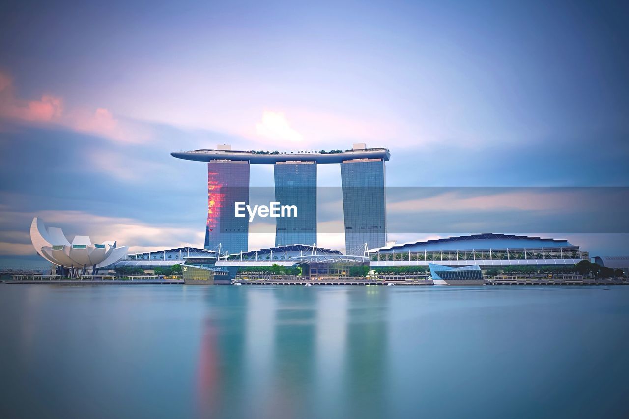 Marina bay sands and artscience against cloudy sky during sunset