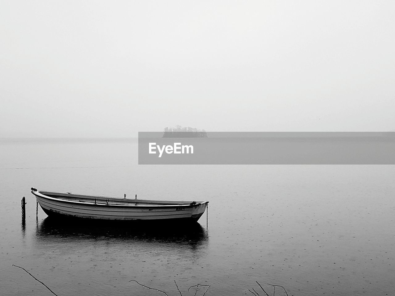 Boat in sea against sky during foggy weather