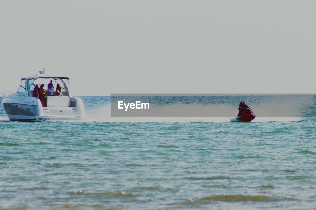 SCENIC VIEW OF SEA WITH TREES IN BACKGROUND