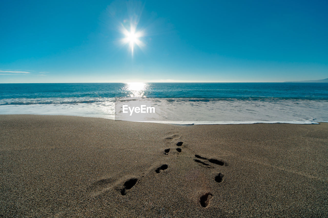 Close-up of beach against sky