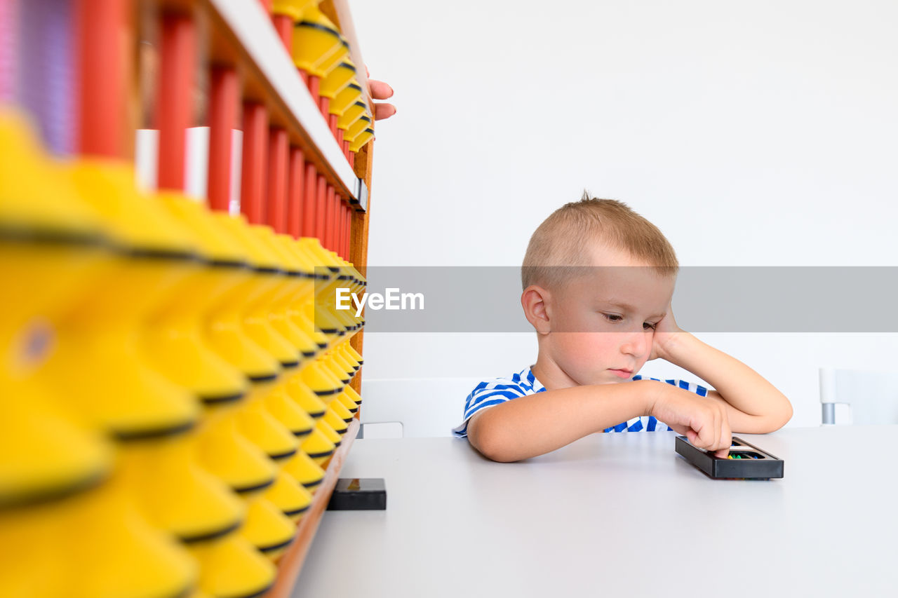 Child with learning difficulty in occupational therapy. a boy during math tutoring session.