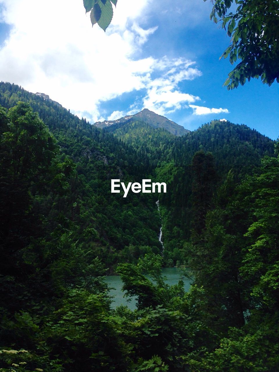 Scenic view of river with mountains in background