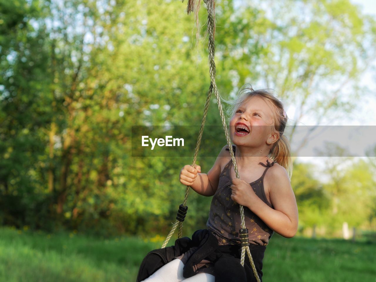Portrait of young girl on swing