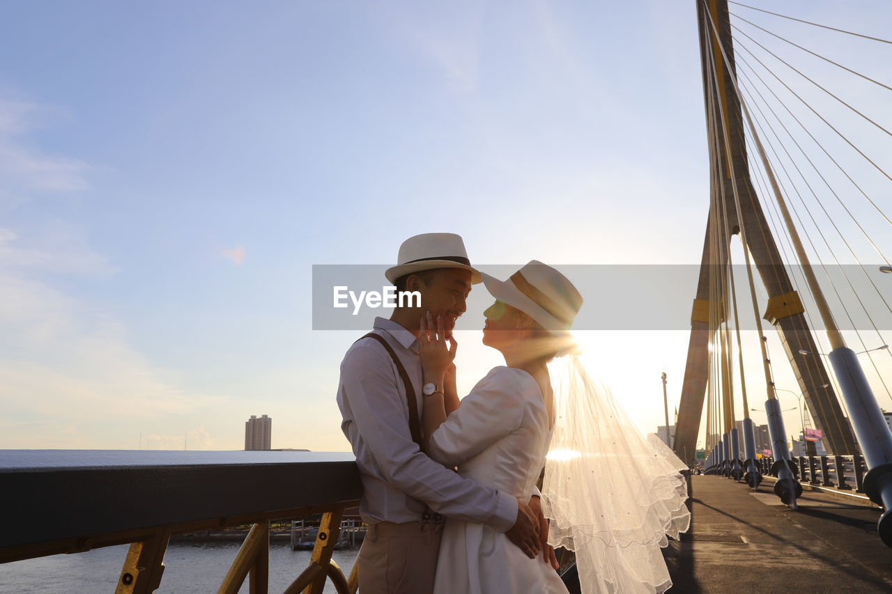 Wedding portrait of asian couple hug together with beautiful sunlight in the evening