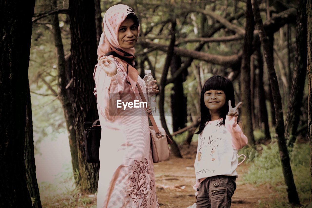 Portrait of mother and daughter in forest