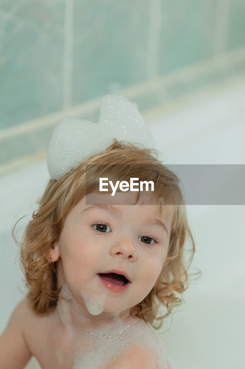 Portrait of cute baby girl in bathroom