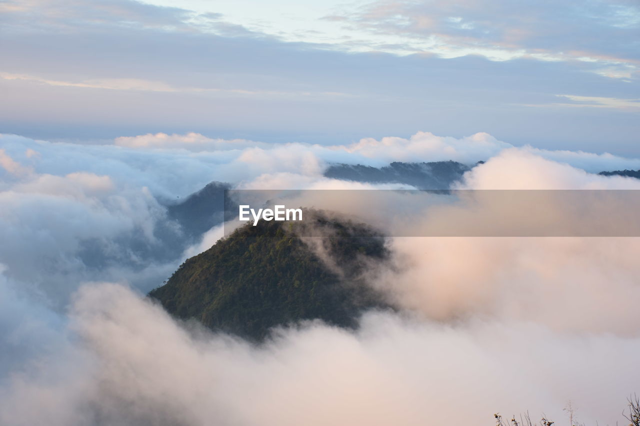 Low angle view of clouds over mountains