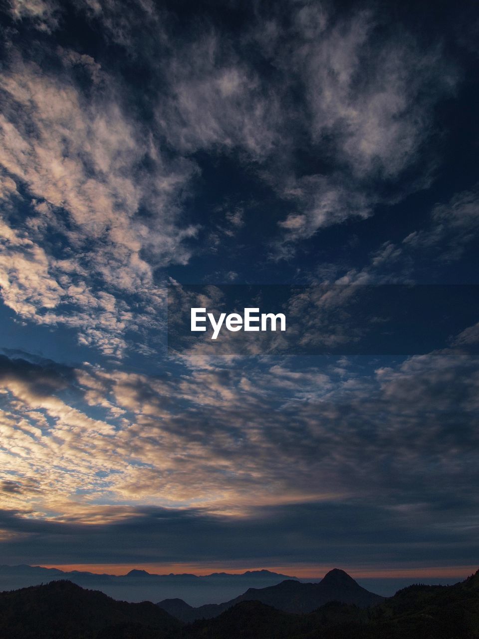 SCENIC VIEW OF DRAMATIC SKY OVER SILHOUETTE MOUNTAINS