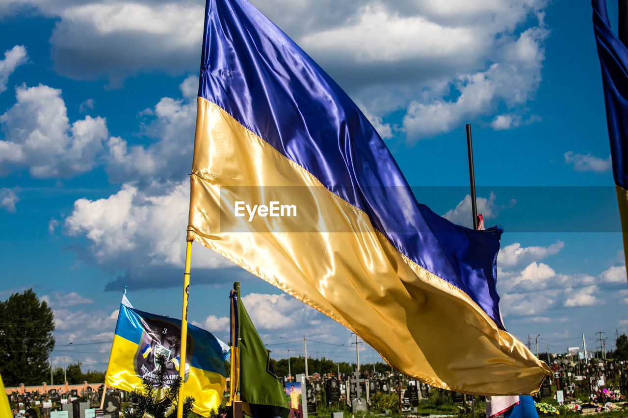 low angle view of flag against cloudy sky