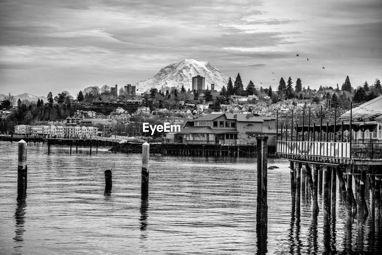 A view of buildings in tacoma, washington with mount rainier behind.