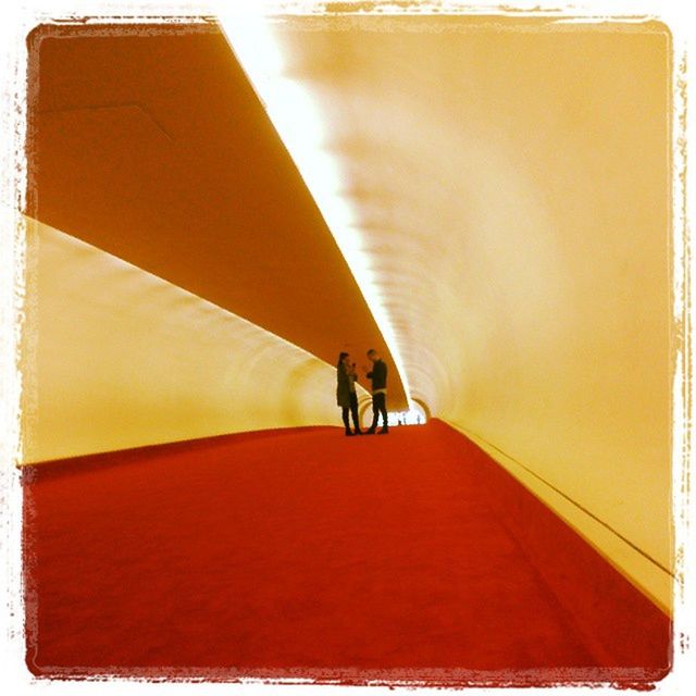 WOMAN WALKING IN TUNNEL