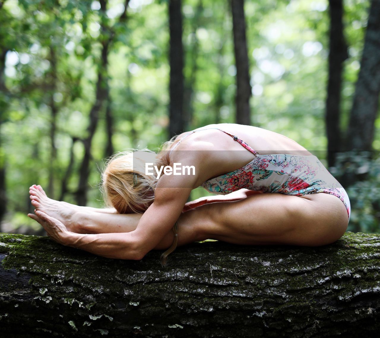 Woman practicing yoga in forest