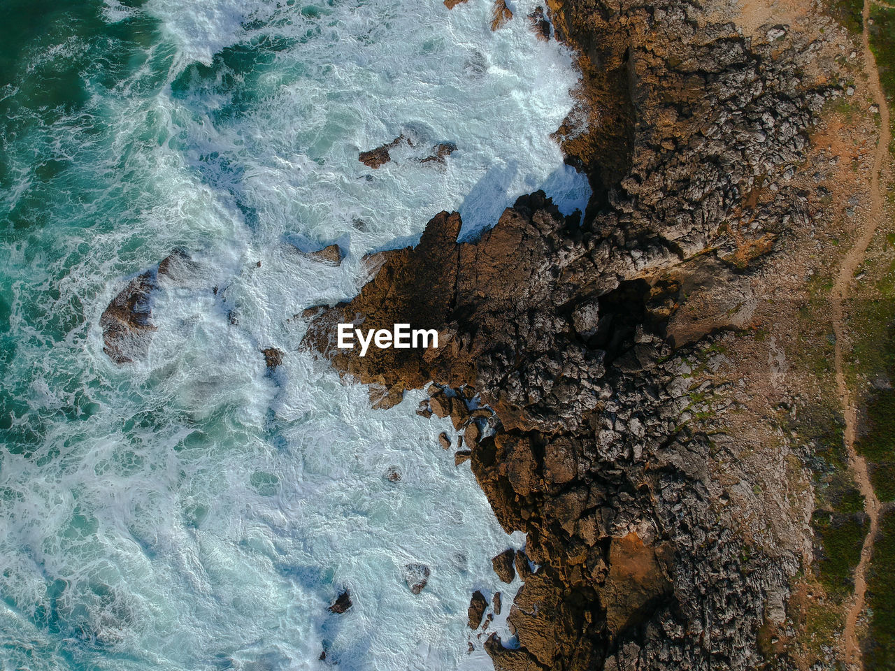 Aerial view of rocks by sea