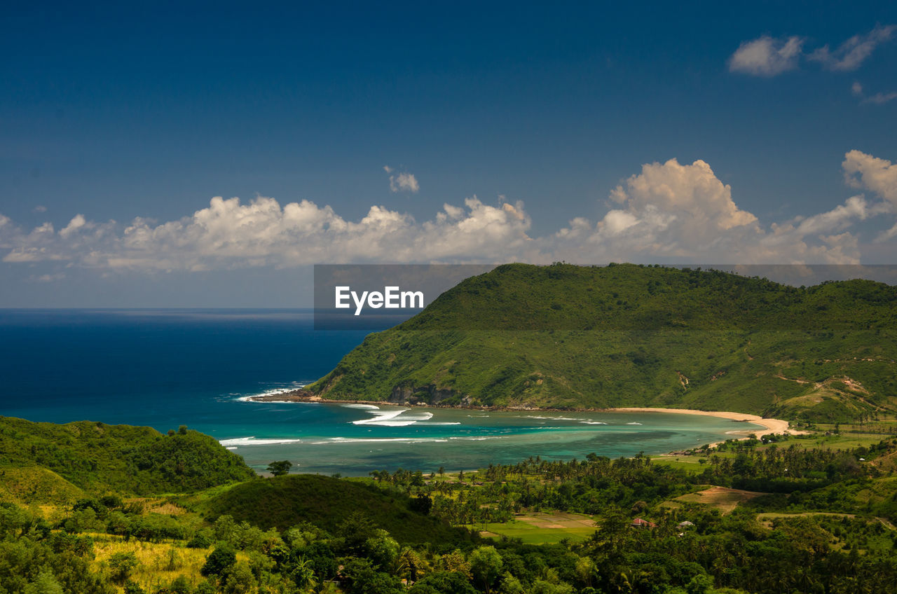 Scenic view of sea and mountains against sky