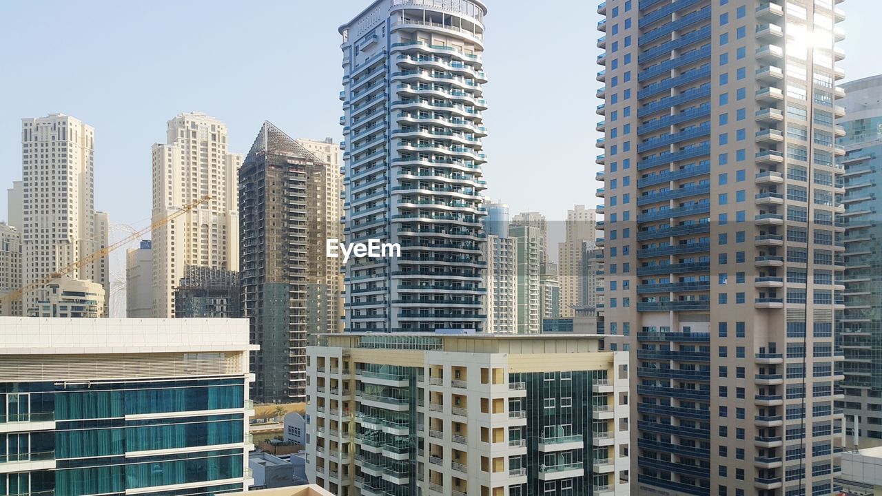 LOW ANGLE VIEW OF MODERN BUILDINGS AGAINST SKY