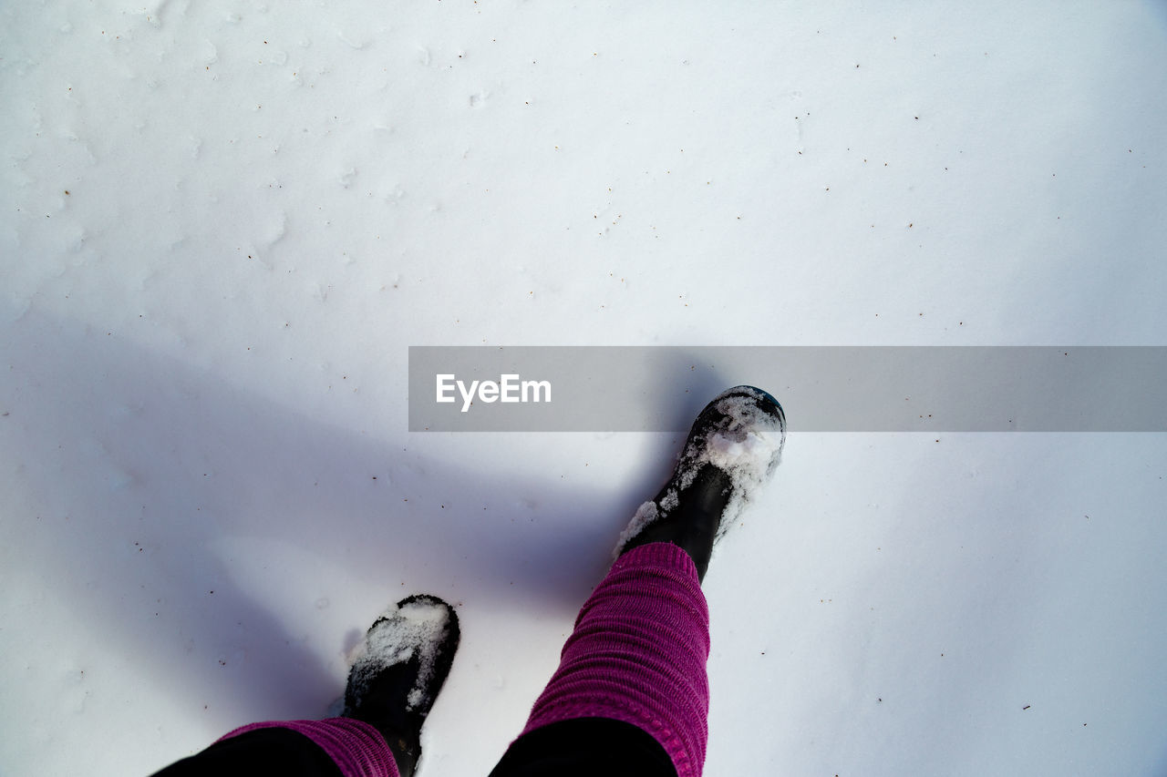 Low section of woman on snow