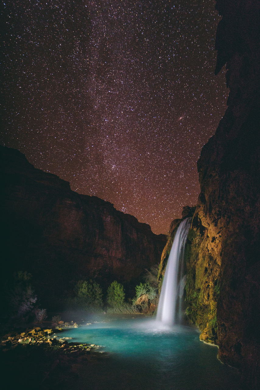 Scenic view of lake against sky at night