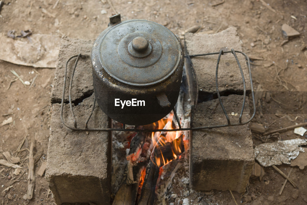 Rustic handmade oven with old iron pan over fire in a brazilian quilombo 