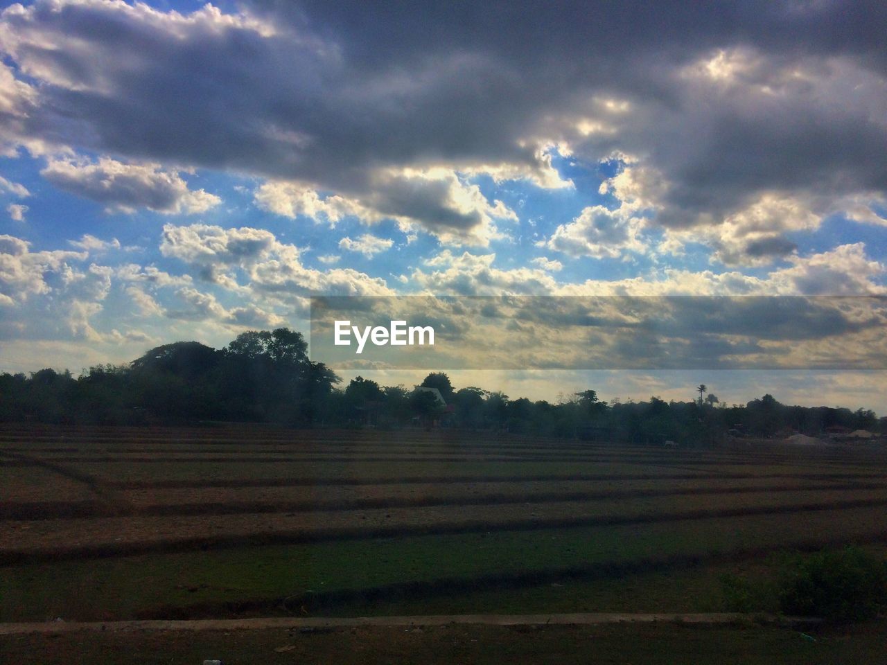 VIEW OF FIELD AGAINST CLOUDY SKY