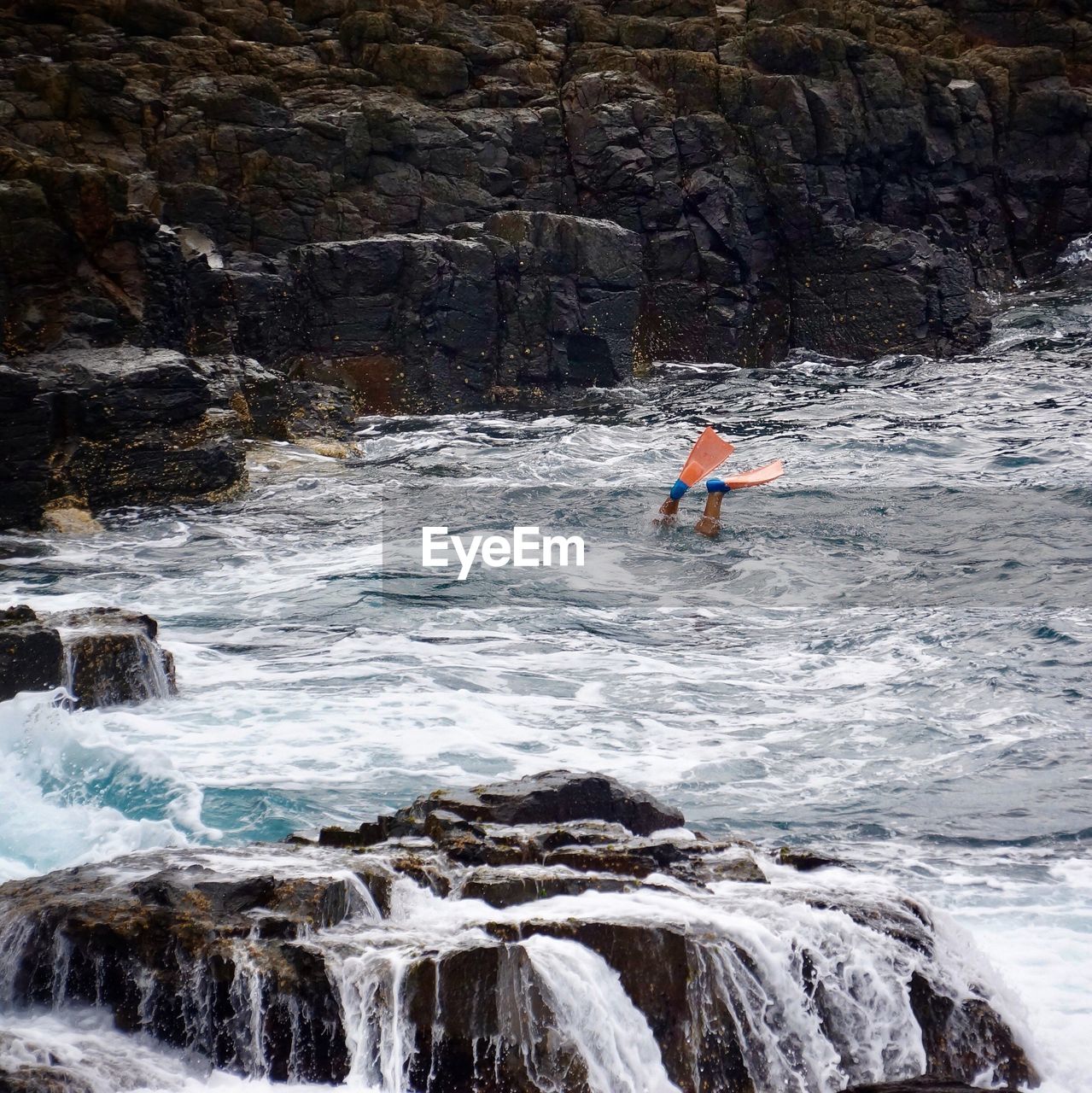 Low section of person diving in river