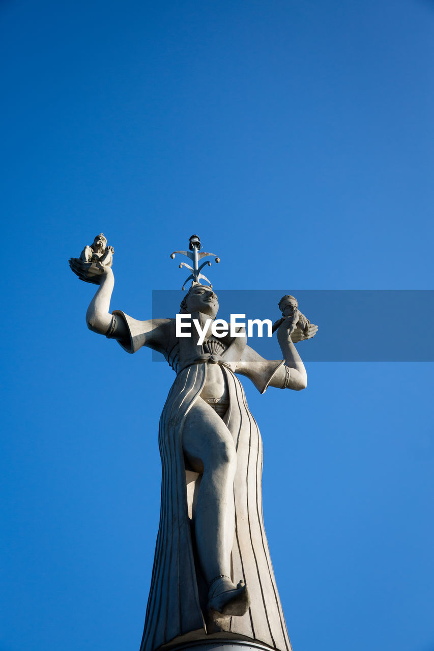 LOW ANGLE VIEW OF ANGEL STATUE AGAINST BLUE SKY