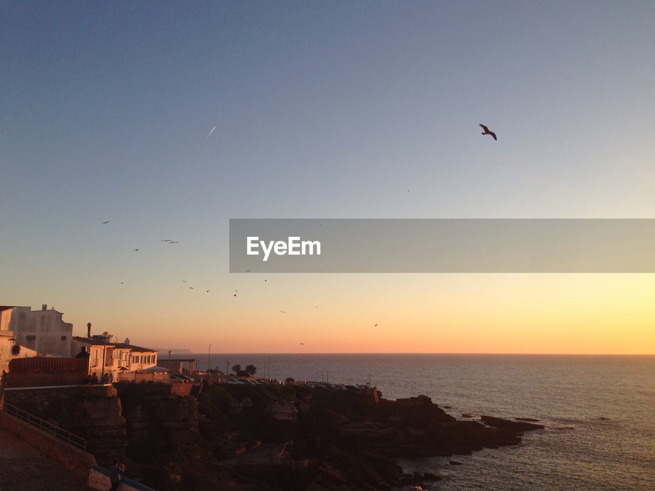 Scenic view of sea against clear sky during sunset