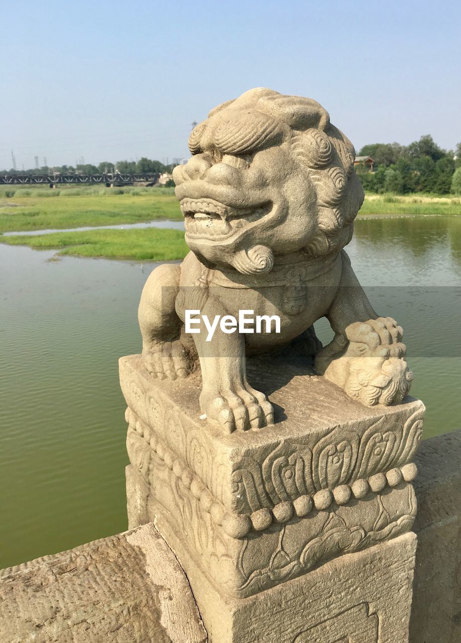 STATUE AGAINST CLEAR SKY IN PARK