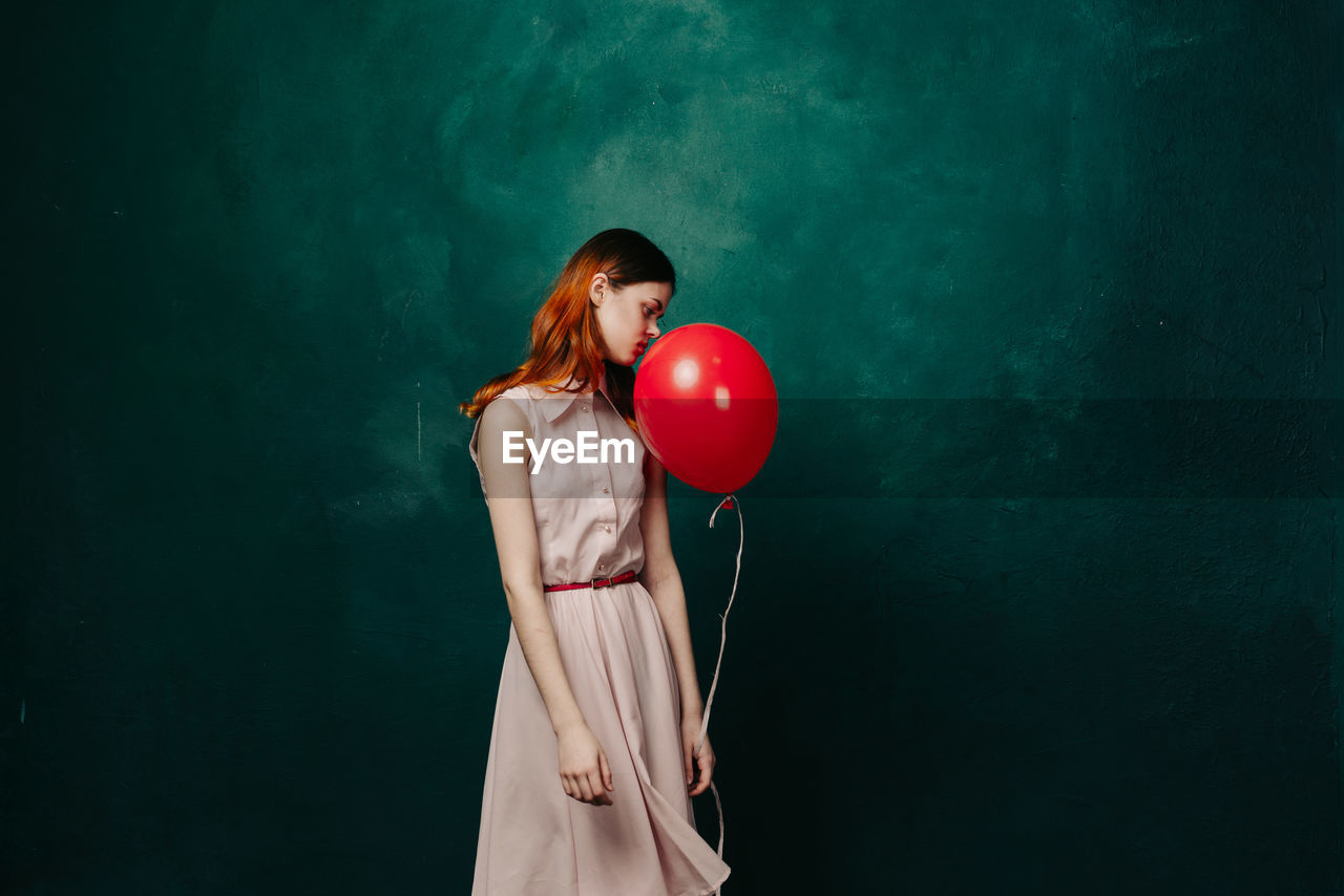 Woman with balloon on balloons