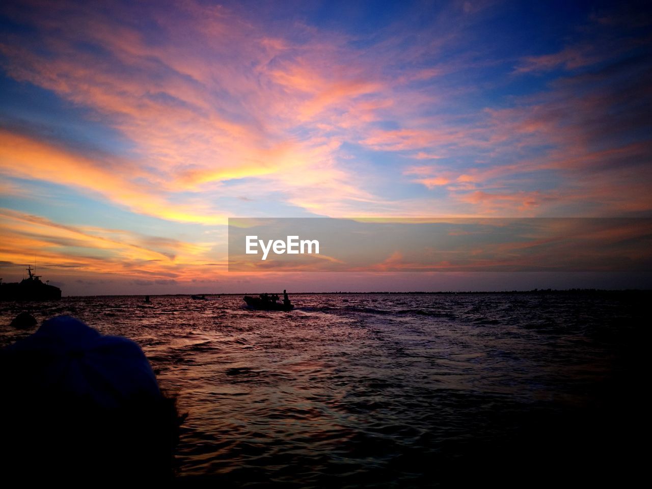 Scenic view of sea against sky at sunset