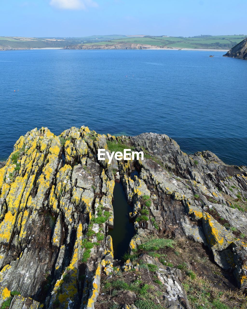 SCENIC VIEW OF SEA AGAINST ROCK FORMATION