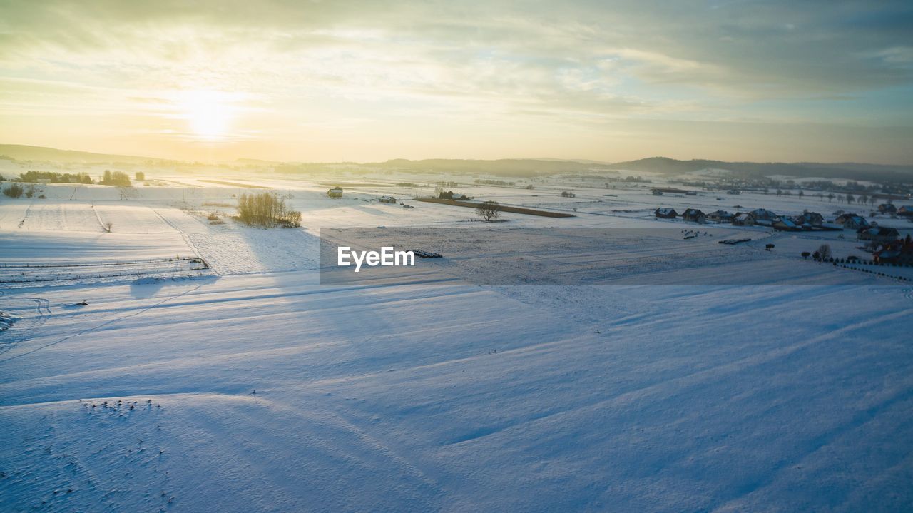 Scenic view of winter landscape at sunset
