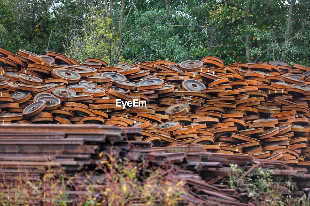 STACK OF LOGS ON FIELD