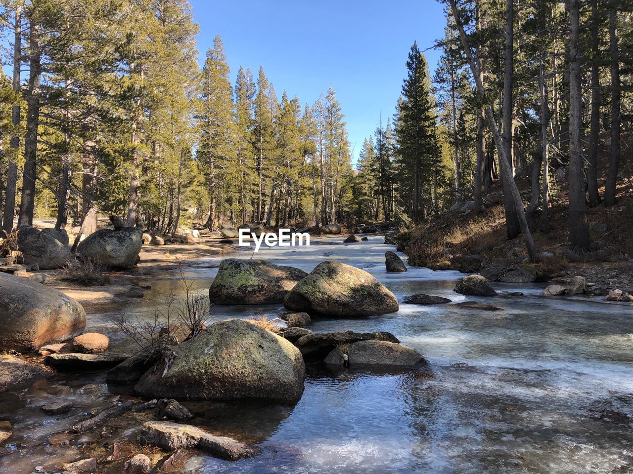 ROCKS BY RIVER AGAINST SKY