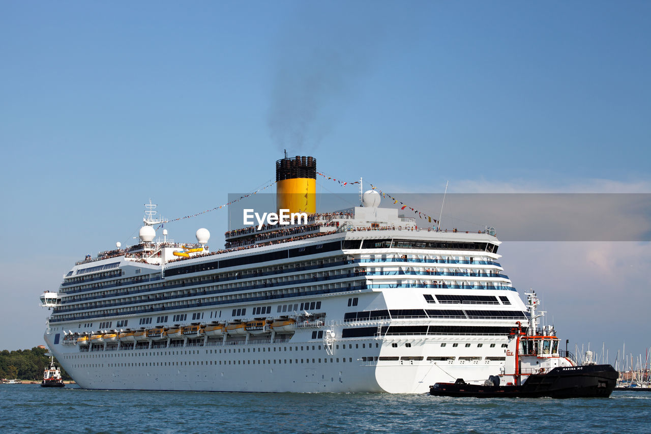 Low angle view of cruise ship on sea against blue sky