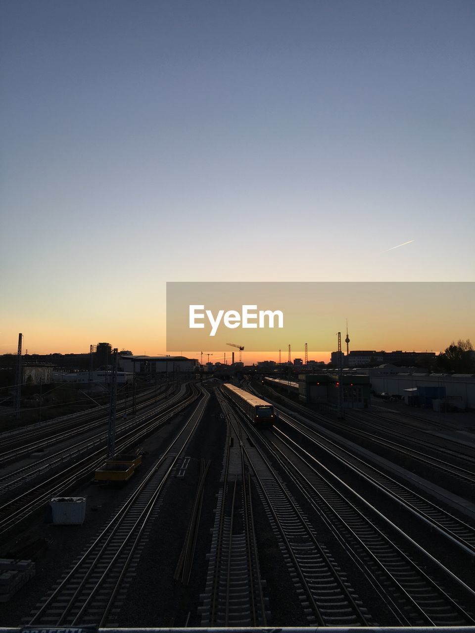 High angle view of railroad tracks against clear sky during sunset