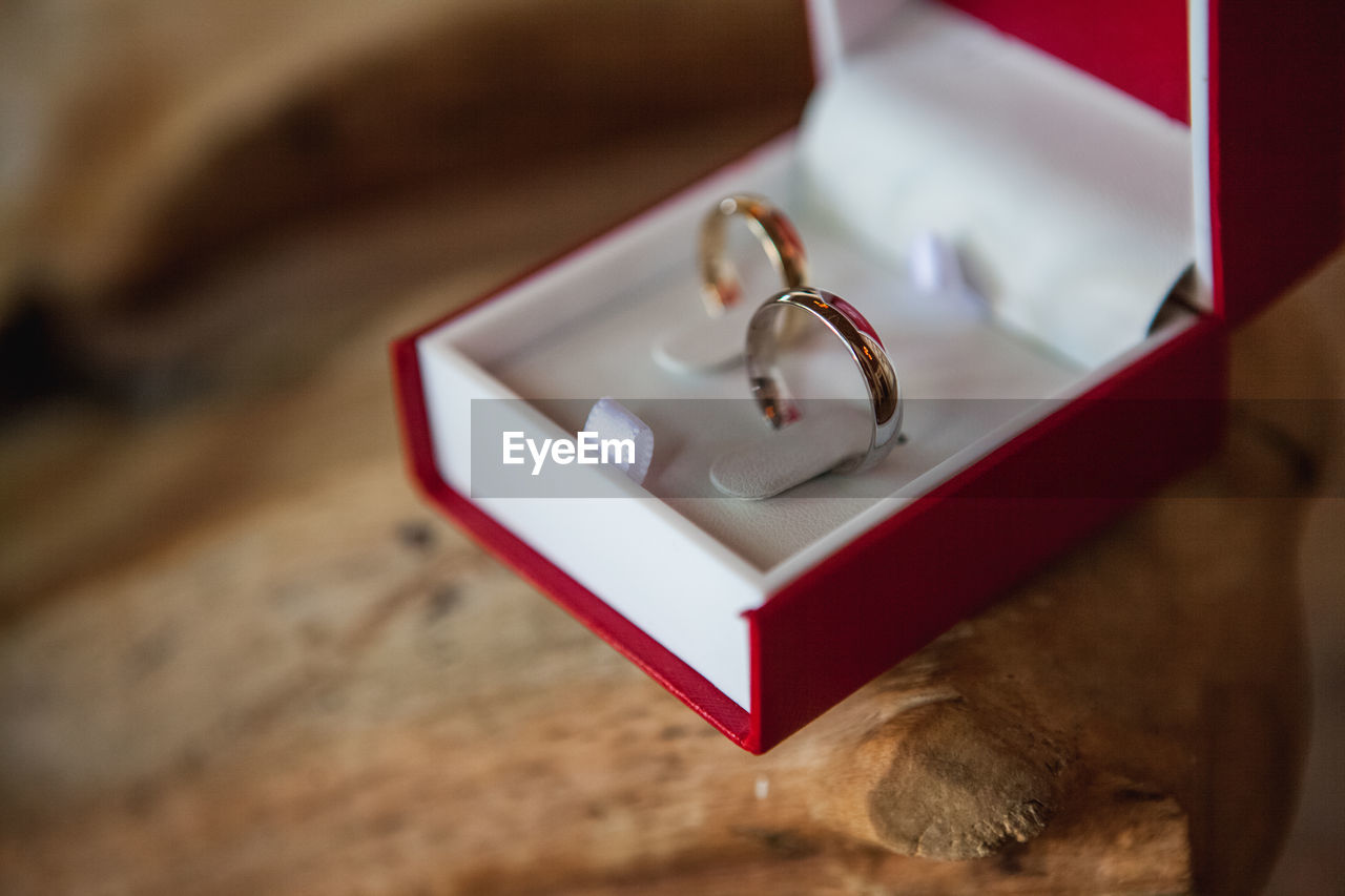 Close-up of wedding rings on wooden table