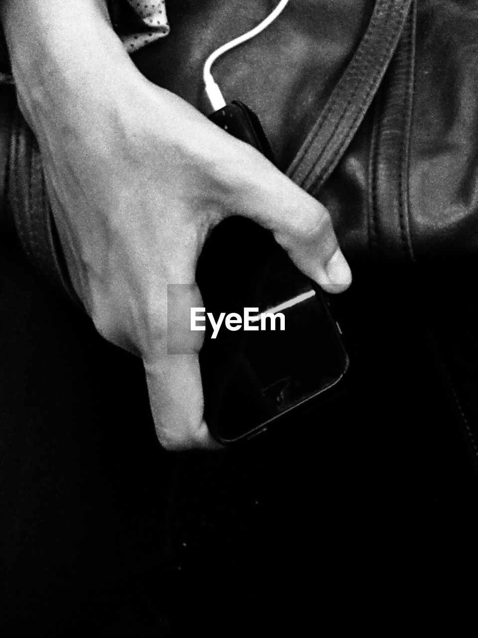 Cropped image of man holding smartphone