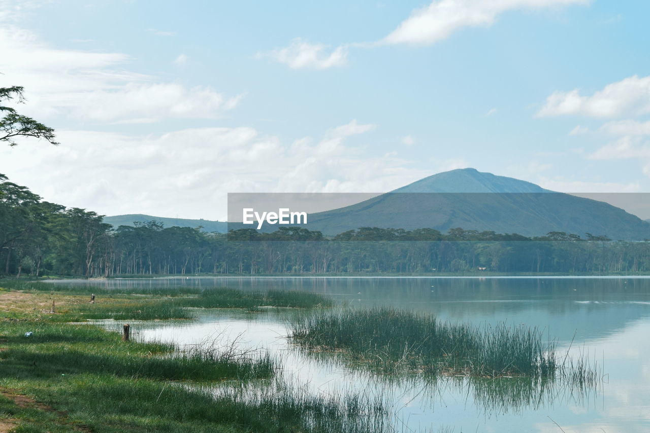 Scenic view of lake and mountains against sky