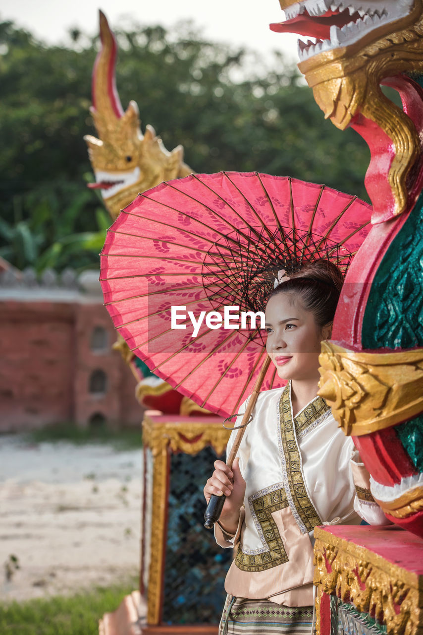 WOMAN HOLDING UMBRELLA