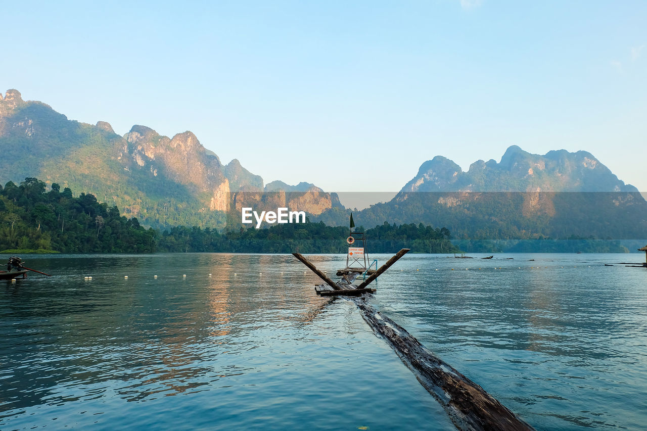 SCENIC VIEW OF SEA AGAINST MOUNTAINS